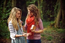 a mother and daughter praying together outdoors 