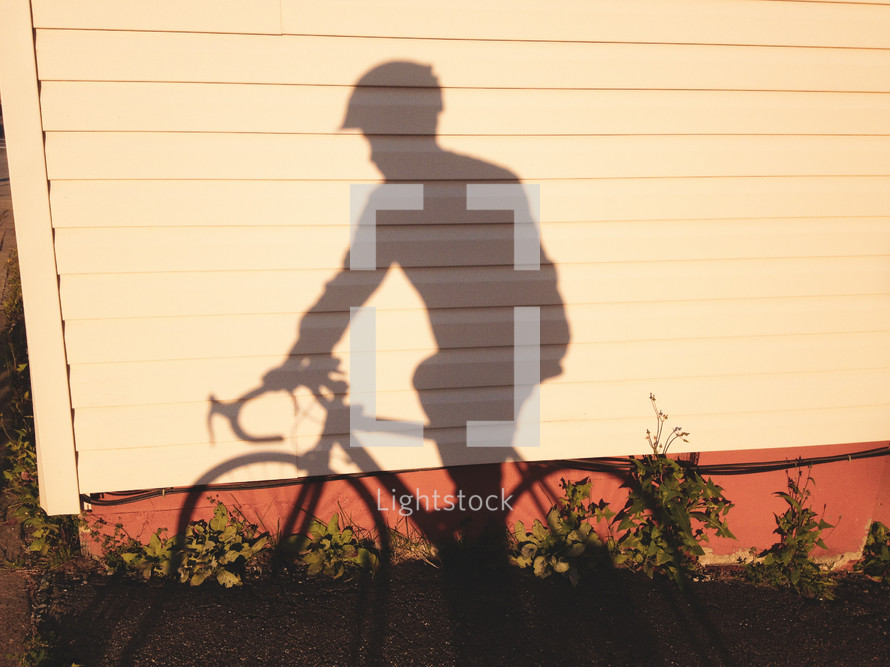 shadow of a man on a bicycle 