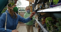Mom and children in face mask shopping in a fish store