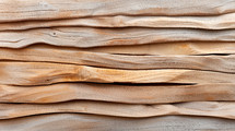 Close-up of layered, wavy plywood texture, showcasing natural wood grain patterns and organic lines, perfect for background or design elements.