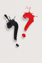 Abstract art featuring black and red paint splashes forming question marks on a white textured background, symbolizing uncertainty or inquiry.