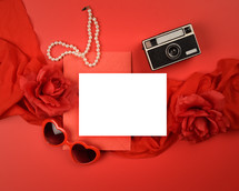 red background, white envelope, hearts, roses, pearls, camera 