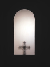 view of a cross through a window opening 