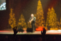 raised hands at a Christmas worship service 