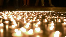 flickering prayer candles at a vigil 