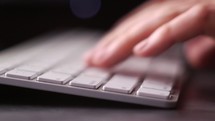 hands typing on a computer keyboard 