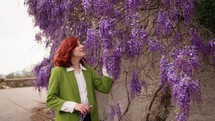 Woman posing with wisteria.