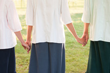 young women holding hands 