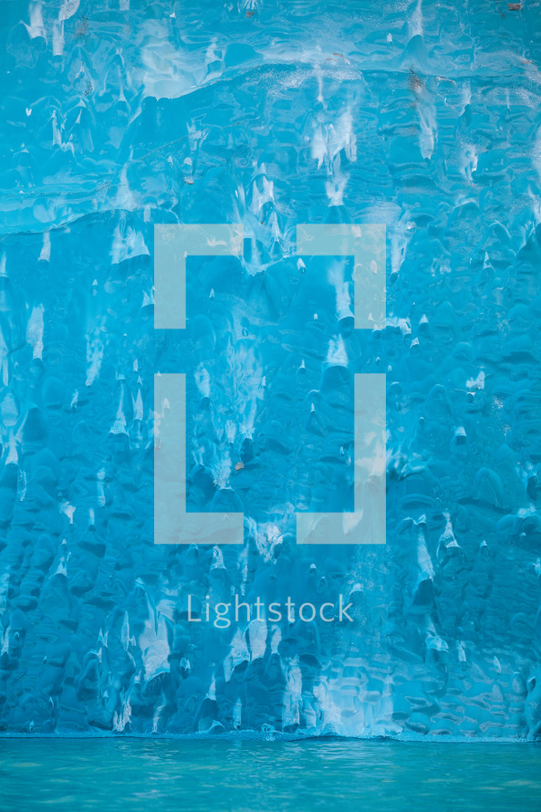 Blue iceberg floating in the water of Endicott Arm