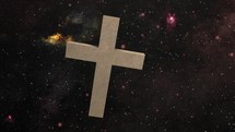 Christian religious crucifix rotates in cosmic space among the stars