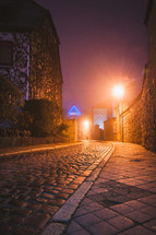bright lights at night and cobblestone street 