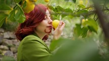 Woman smelling a lemon.