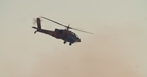Israeli Air Force Apache Longbow military helicopter attacking targets with canon