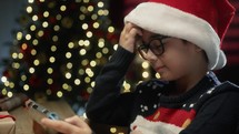 Boy using his Smartphone to show his Christmas tree 