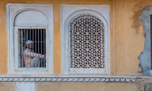 a man looking out a window in India 