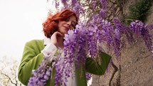 Woman posing with wisteria.