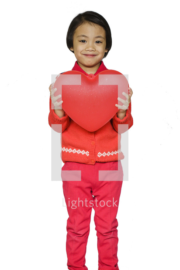 a child holding a heart 