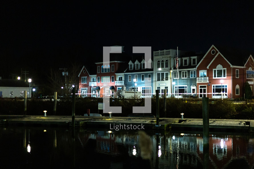 Buildings by the shore at night