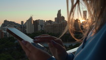 Woman using a phone in a city setting