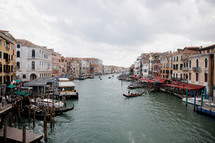 A stunning view from the Rialto Bridge, Venice in a cloudy day. Venetian Water Bus, Vaporetto Across The Grand Canal In Venice, Italy