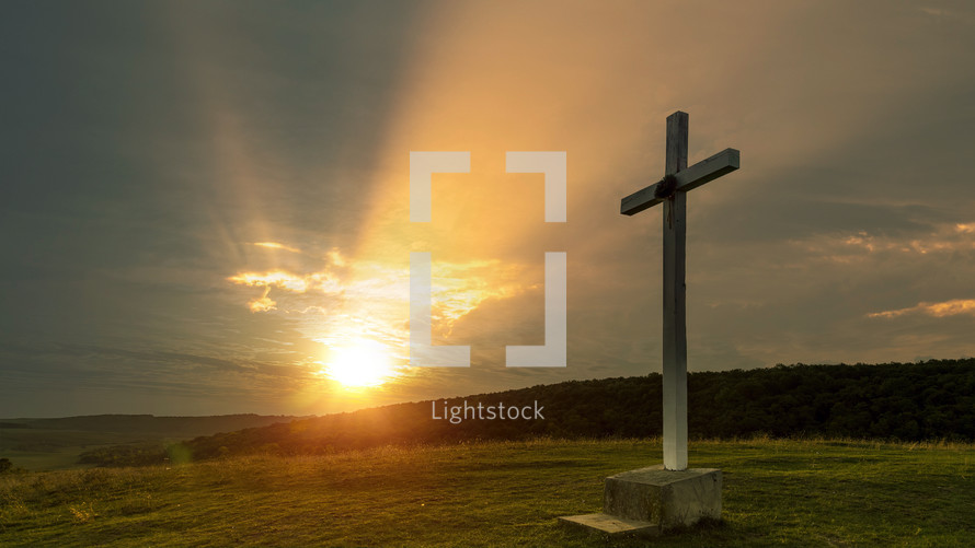 Cross on the hill at sunrise
