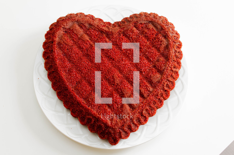 A red heart shaped cake.