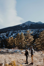 a couple hiking in the mountains in winter 