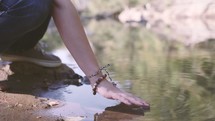 a woman placing her hands on  water 