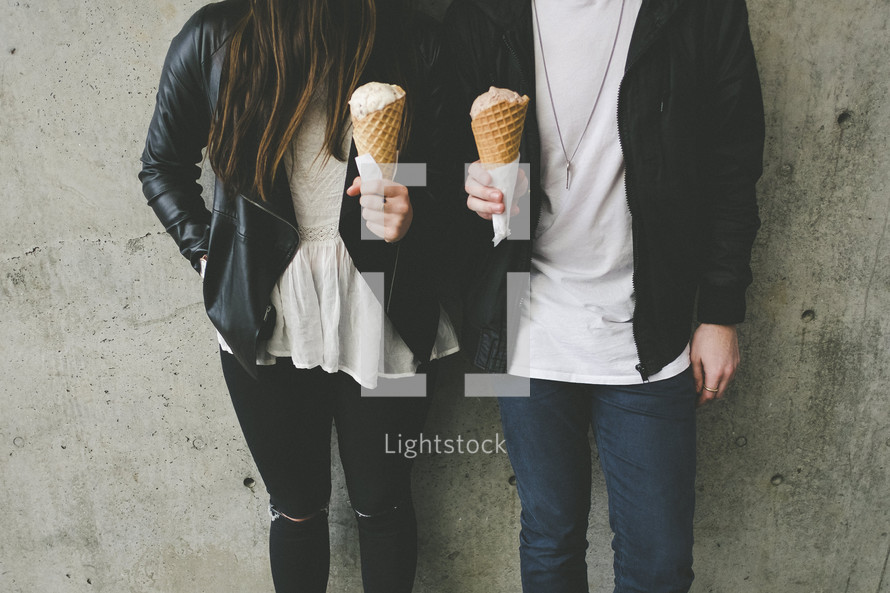 a couple holding ice cream cones 
