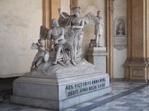 TURIN, ITALY - CIRCA AUGUST 2021: Fama che incatena il Tempo (translation The Fame that chains Time) sculpture by Ignazio and Filippo Collino circa 1788 at Turin University