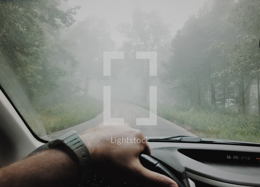 driving down a foggy rural road 