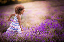 a little girl running in a lavender field 