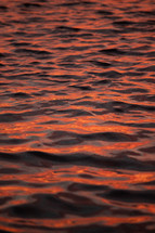 orange sky reflecting on water 