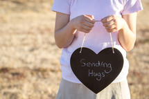 Sending Hugs Written on Chalkboard