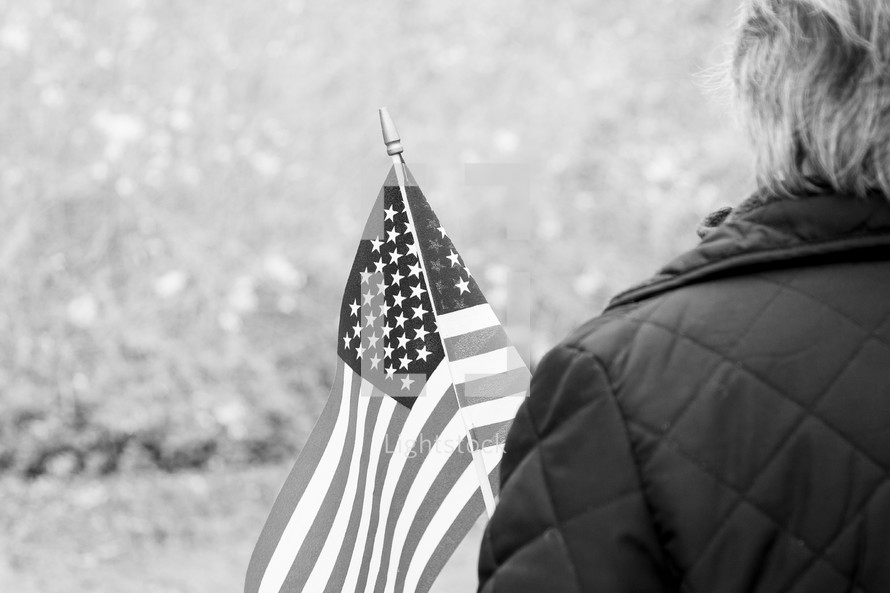 Black and white of woman holding american flag