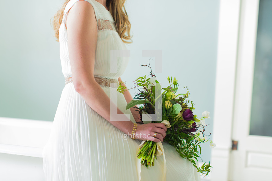 a bride holding a bouquet of flowers 