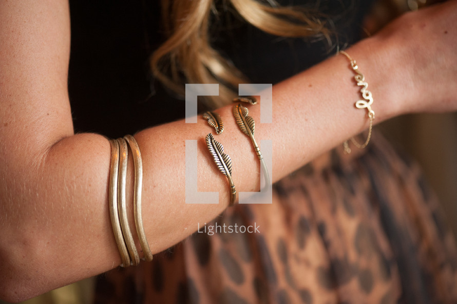 Woman's arm with bracelets.