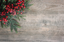 Christmas background with evergreen pine branches and red winter berries