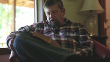 a man reading a Bible out loud 