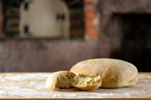 Homemade wheat bread on floured surface