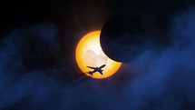 Solar eclipse with a plane silhouette and fog

