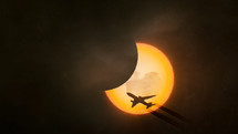 Solar eclipse with an airplane silhouette

