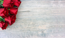 red roses on a wood background 