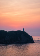 colorful sky during sunrise over a silhouetted lighthouse on the Pacific Coast of Chiba Prefecture, Japan