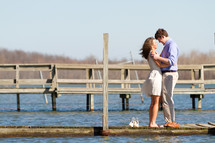 A couple hugging on a dock