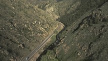 Drone footage over a highway in the Colorado mountains.
