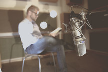 a man reading a book in a studio 