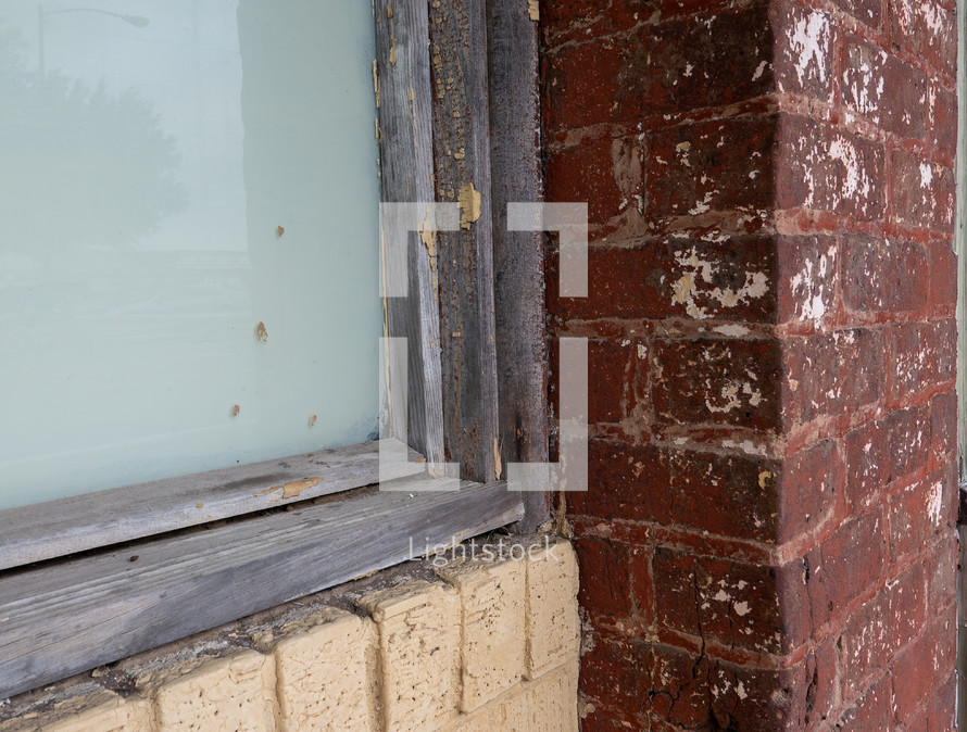 corner of window and brick wall, weathered building façade detail