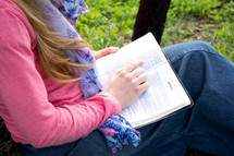 woman reading a Bible outdoors
