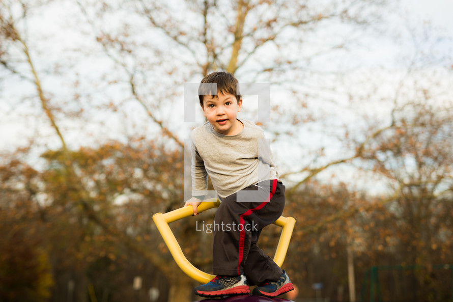 a boy on a climber on a playground 